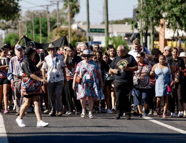 Group of people walking on the road in Walgett, NSW.
