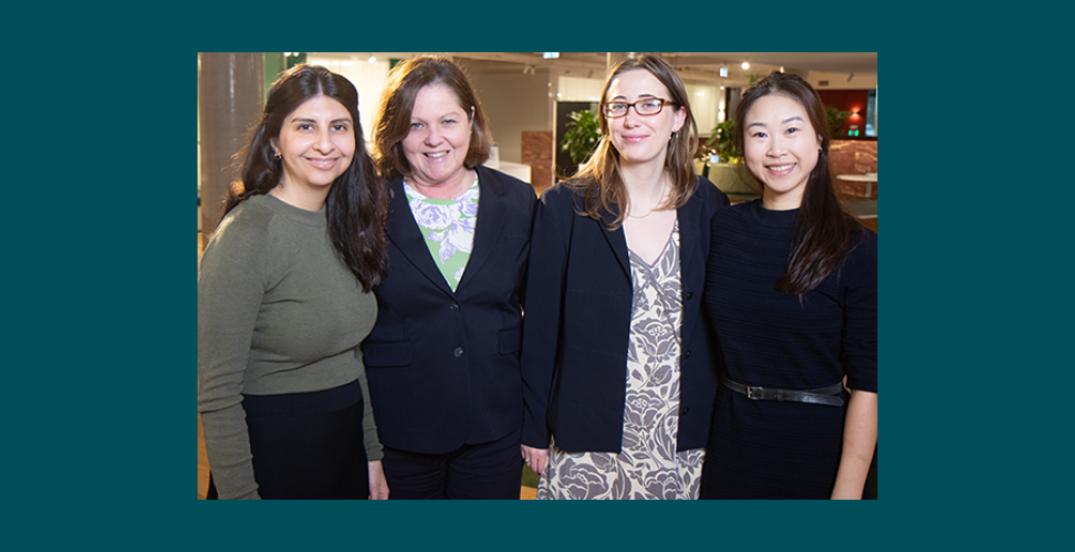 Four women looking at camera and smiling